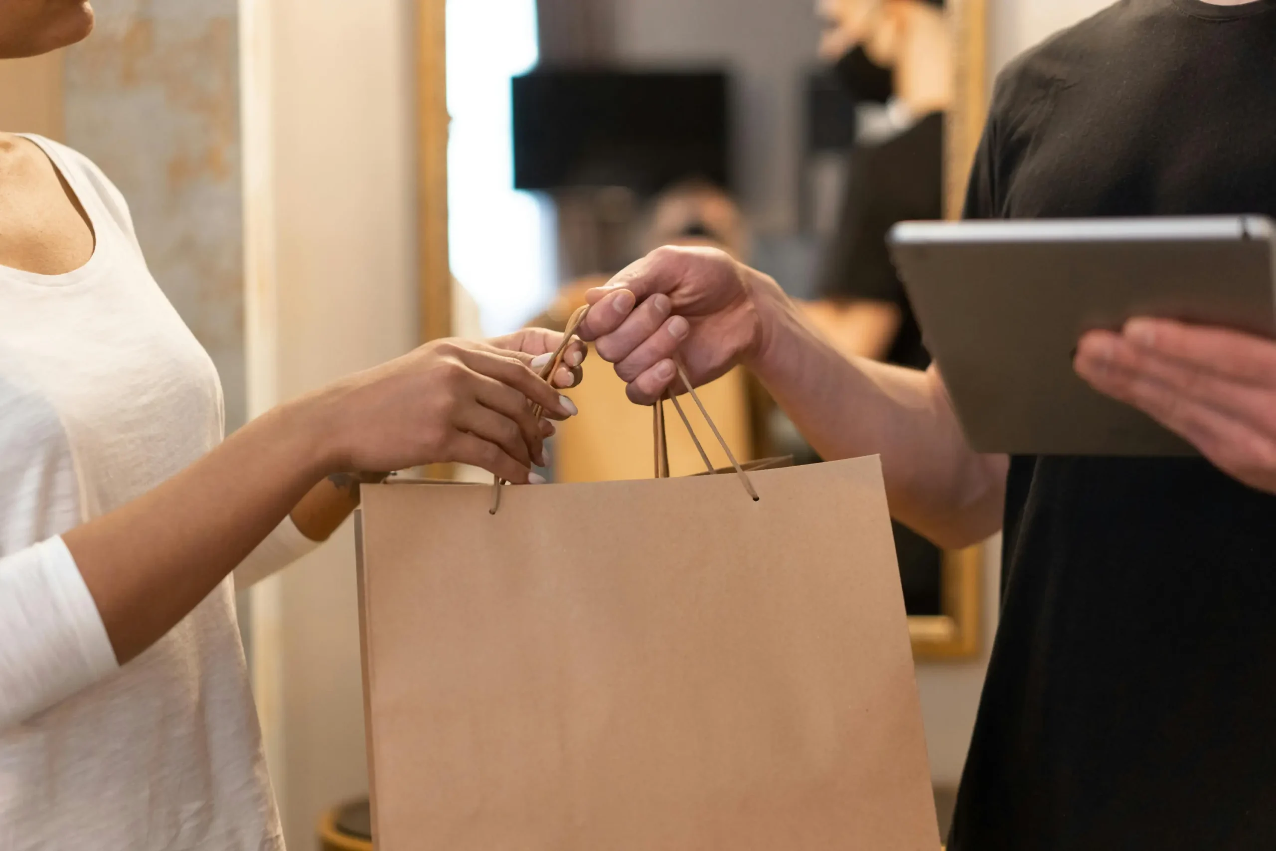 A person handing over a package to customer